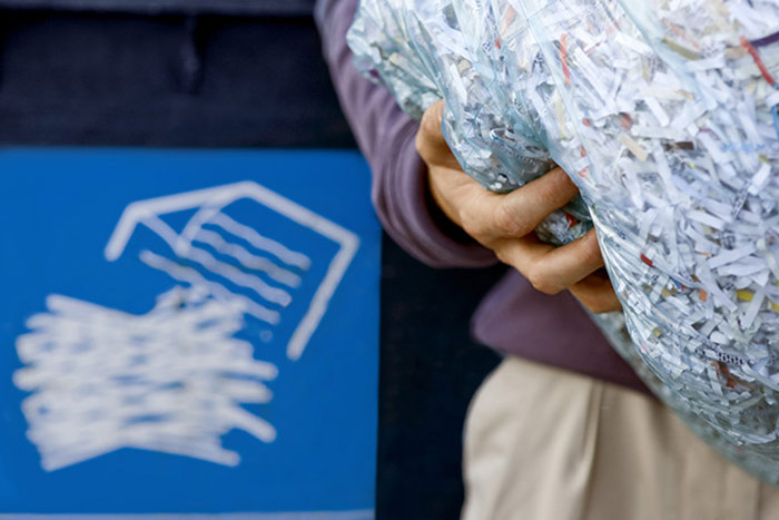 Holding shredded paper by A1 Shredding and Recycling