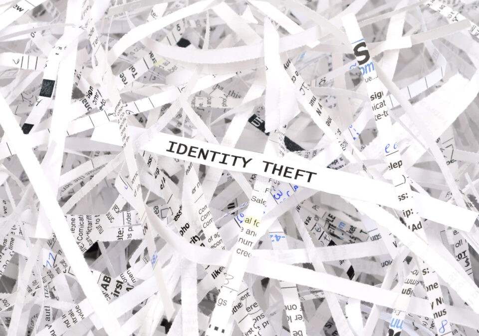 Identity Theft Text Visible on Shredded Paper Strips After Legal Document Destruction in Georgia
